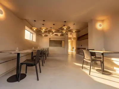 a dining room with tables and chairs and lights at Guesthouse Ubuntu - Stellenbosch in Stellenbosch