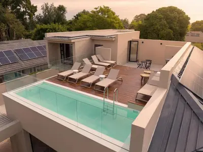 a house with a swimming pool on a roof at Guesthouse Ubuntu - Stellenbosch in Stellenbosch