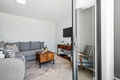 a living room with a couch and a table at Beach Break 17 in Cape Town