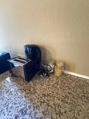 a microwave sitting on the floor next to a wall at Kabana Guest House Morgenzicht in Windsor Park
