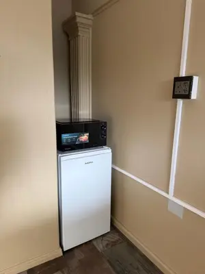 a small white refrigerator with a microwave on top of it at Kabana Guest House Morgenzicht in Windsor Park