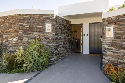 a hallway with a brick wall and a door at Winelands Luxury Accommodation in Stellenbosch