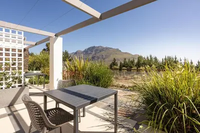 a table and chairs on a patio with a view at Winelands Luxury Unit in Stellenbosch