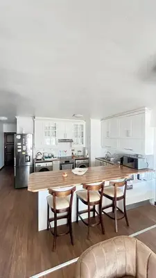 a kitchen with a large wooden table and chairs at Luxury Beach Front Apartment in Strand