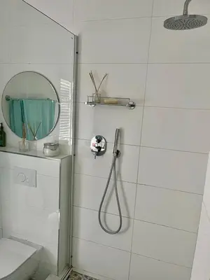 a bathroom with a shower and a mirror at Luxury Beach Front Apartment in Strand