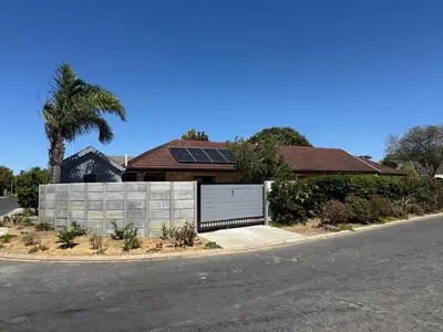 a house with solar panels on the side of the road at Welcome Home in Somerset West