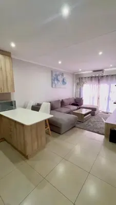 a living room with a couch and a table at Your Perfect Little Cozy Getaway in Cape Town