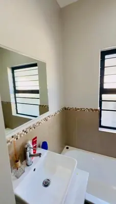 a bathroom with a white sink and a mirror at Your Perfect Little Cozy Getaway in Cape Town