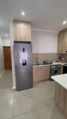 a kitchen with a stainless steel refrigerator in it at Your Perfect Little Cozy Getaway in Cape Town