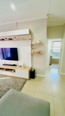 a living room with a tv and a couch at Your Perfect Little Cozy Getaway in Cape Town