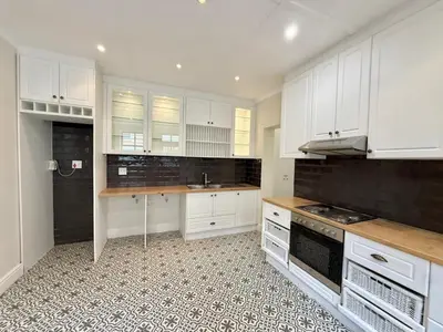 a kitchen with white cabinets and a counter top at 3 Bedroom Vintage Home in Cape Town