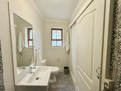 a white bathroom with a sink and a toilet at 3 Bedroom Vintage Home in Cape Town