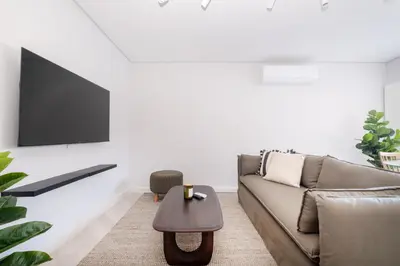 a living room with a couch and a coffee table at 116 Paarl - Lux 1 Bedroom Apt with AC and Parking in Paarl