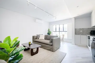 a living room with a couch and a table at 116 Paarl - Lux 1 Bedroom Apt with AC and Parking in Paarl