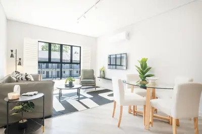 a living room with a table and a couch at 213 Paarl 2 Bedroom Lux Aprt With Parking & Aircon in Paarl