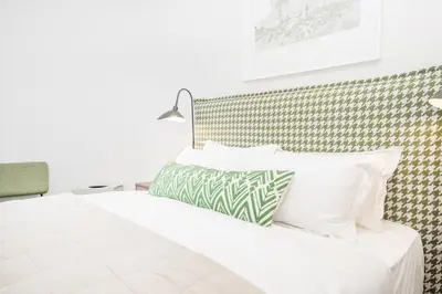 a bedroom with a bed with white sheets and pillows at 213 Paarl 2 Bedroom Lux Aprt With Parking & Aircon in Paarl
