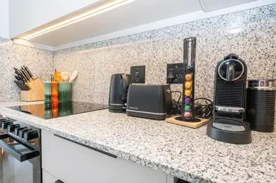 a kitchen with a counter with a coffee maker on it at 213 Paarl 2 Bedroom Lux Aprt With Parking & Aircon in Paarl