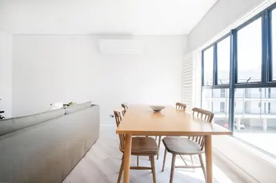 a dining room with a wooden table and chairs at 216 Paarl Lux 1 Bdrm Apt with Parking and AC in Paarl