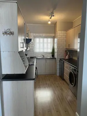 a kitchen with a sink and a dishwasher at Strandsig 308, 96 beach road in Strand