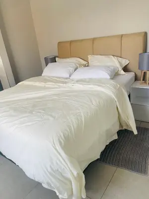 a large white bed with white sheets and pillows at Cape Coral in Cape Town