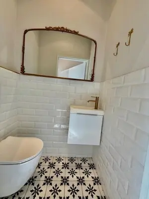 a bathroom with a white toilet and a mirror at 26 at Blumenhof in Stellenbosch