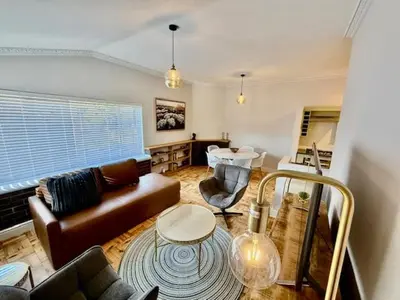 a living room with a couch and a table at 26 at Blumenhof in Stellenbosch