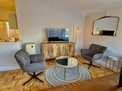 a living room with two chairs and a table at 26 at Blumenhof in Stellenbosch