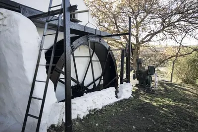 a ladder next to a building with snow on it at Beaumont Family Wines in Botrivier