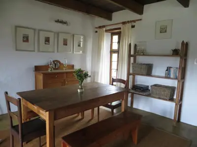 a dining room with a wooden table and chairs at Beaumont Family Wines in Botrivier