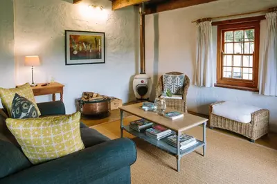 a living room with a couch and a table at Beaumont Family Wines in Botrivier