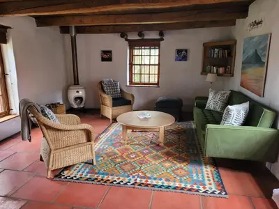 a living room with a table and chairs at Beaumont Family Wines in Botrivier