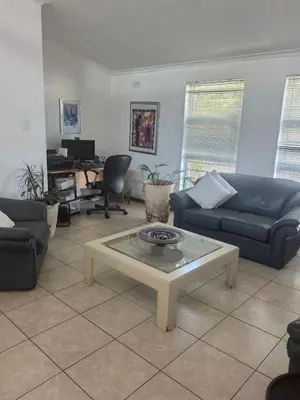 a living room with couches and a coffee table at 22 on BREEZAND in Cape Town