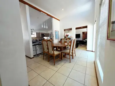 a kitchen and dining room with a table and chairs at 22 on BREEZAND in Cape Town
