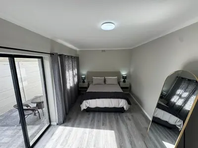 a bedroom with a bed and a large window at Lansdowne Lodge in Welton