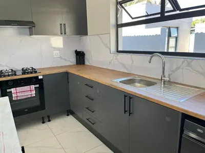 a kitchen with a counter and a sink and a window at Lansdowne Lodge in Welton
