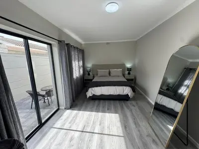 a bedroom with a bed and a large window at Lansdowne Lodge in Welton