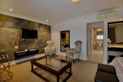 a living room with a couch and a coffee table at The Coach House at Val du Charron in Wellington