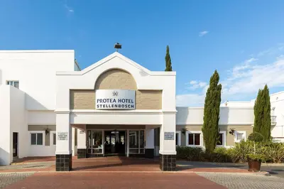 a white building with a sign that reads motorola hotel shakedown at Protea Hotel by Marriott Stellenbosch & Conference Centre in Stellenbosch