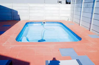 a swimming pool in the middle of a building at Milino Guest House in Cape Town
