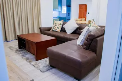 a living room with two couches and a coffee table at Milino Guest House in Cape Town