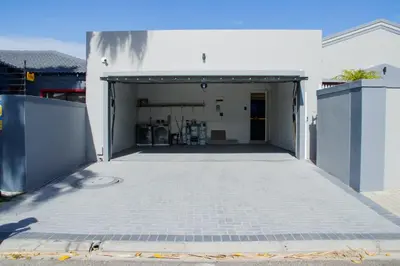 a garage with a door open in a building at Milino Guest House in Cape Town
