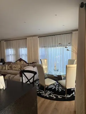 a living room with a dining room table and chairs at Durbanville apartment in Durbanville