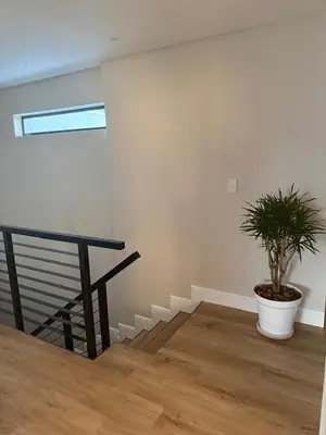 a potted plant in a room with a staircase at Durbanville apartment in Durbanville