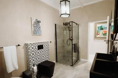a bathroom with a shower with a glass door at Coats Haven in Hermanus