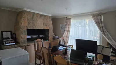 a dining room with a table with two computers on it at Nyati in Cape Town