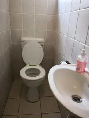 a bathroom with a toilet and a sink at Duplex in Tableview in Cape Town