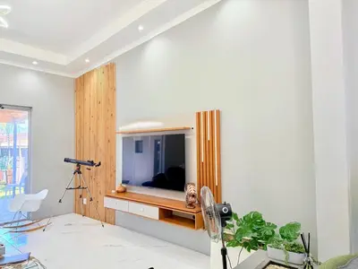 a living room with a tv on a wall at Spacious house for 11 Guests near Canal Walk Mall in Cape Town