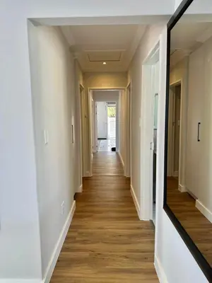 a hallway of a home with a mirror at Spacious Family Friendly Richwood in Cape Town