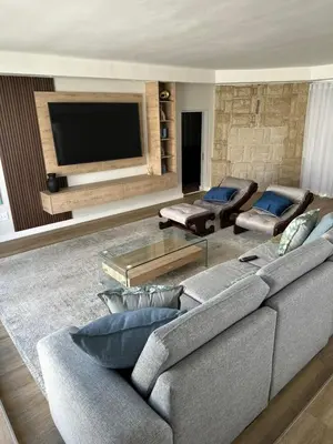 a living room with a couch and a flat screen tv at Spacious Family Friendly Richwood in Cape Town