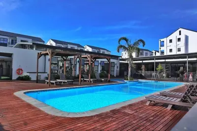 a swimming pool in front of a building at 2 bedrooms in Cape Town